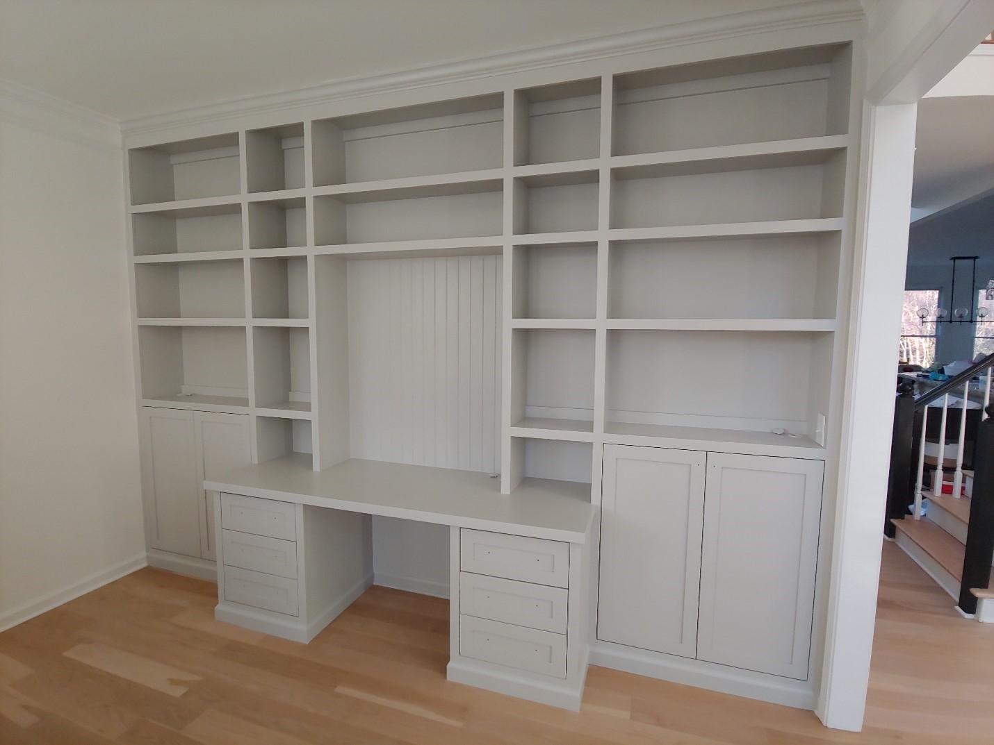Home Office Built-in with inset doors/drawers, fixed shelving and beadboard center panel